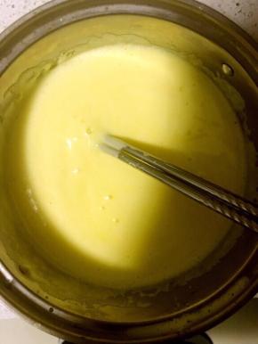 4.牛奶离火后，将牛奶缓慢倒入蛋黄液中，倒入过程中要不停搅拌，免得把蛋黄液烫成蛋花汤！搅拌均匀后将蛋黄液倒入奶锅，全程小火，至微开，一定要小火，并加热过程中不停搅拌，否则会结块，影响口感！此加热步骤也可隔水加热，加热中同样需要不停搅拌，总之不要变成块状！