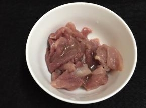 前腿肉切薄片，放入碗中加入少许玉米油用手抓匀备用。