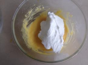 将1/3打发好的蛋白霜加入到蛋黄糊里