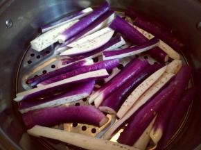 把切好的茄子放在蒸屉上，隔水蒸熟，冷水入锅上气后大约5分钟差不多了。