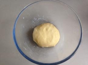 和好的南瓜面团放入盆里，盖上保鲜膜。室温高，直接在室温下发酵即可