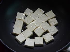热油锅，将豆腐放进锅里煎，洒点盐