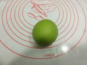 将绿色面团包裹住白色面团，收口的面团尽量多些，防止发酵时面团爆开。收口捏紧，朝下放置。