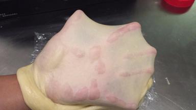 揉至10分钟时放入黄油，继续揉至可拉出薄膜即可（圆孔不需太光滑，呈锯齿状）