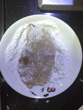 猪排摊平，放入淀粉里裹薄粉
