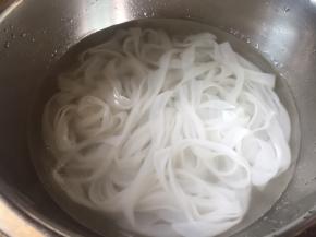 河粉皮，放入清水中，浸泡清洗下；