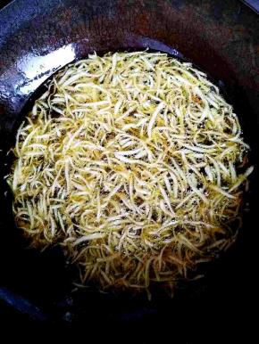 锅中热油，油温较高的时候分次放入土豆丝，炸至金黄。