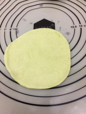 在拿个绿色面团，擀大一点的圆饼