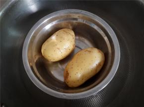 土豆洗净带皮放锅里蒸熟。