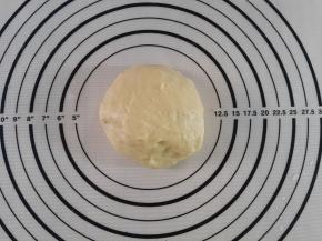 这个时候就取出面团手揉10分钟，用擀面杖擀出气泡，整理光滑。