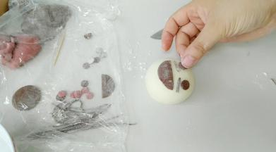 贴上刘海，眉毛，眼睛。粘不住时，蘸些水。