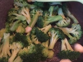 锅中大蒜头爆香放入西兰花翻炒