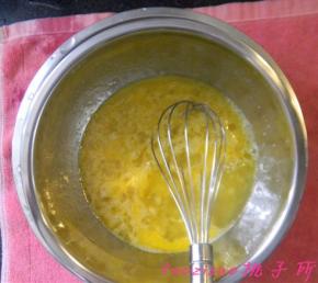 将蛋液盆隔水加热（水温热即可），用手动打蛋器将蛋液、砂糖搅拌均匀，待砂糖基本溶化后，将打蛋盆离开热水；