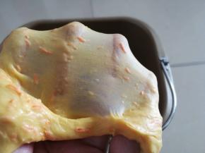 揉至能拉出如图面膜，即可保鲜膜覆盖进行基础发酵（室温30度，约55分钟）。