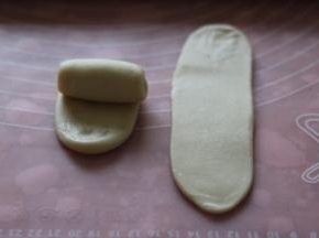 取一个卷再次擀开，擀成长舌型，翻面从上往下卷起。