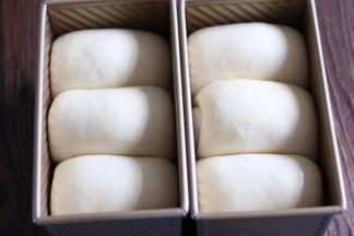 面团发酵至吐司盒九分满，表面刷全蛋液。