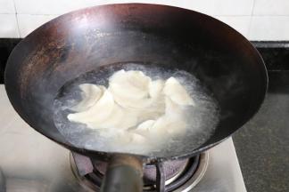 锅中水烧开后放入饺子，水煮沸饺子浮起后加入适量冷水，烧开后再加入冷水，加3次冷水后饺子浮起即可捞出；