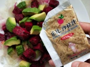 在放上剩下的火龙果和牛油果，准备一袋丘比培煎沙拉汁