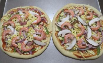 14.食材和芝士碎交错这撒在饼皮上，最后摆上剥壳的虾仁。