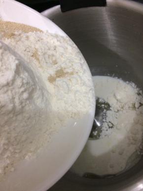 在把面粉、盐和酵母倒入