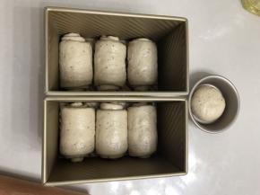 自上而下自然卷起，2.5 至3 圈刚刚好，以吐司盒底部三个小圆点为中心摆放。