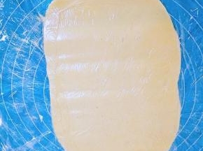 垫一层保鲜膜，面团放在保鲜膜上，上面再盖一层保鲜膜，擀成比土司盒略小的长方形，放入冰箱冷藏备用