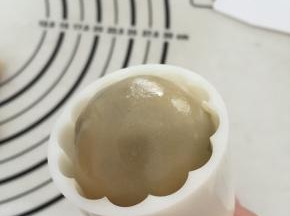 放入包好内馅的面团，用手轻轻压实；