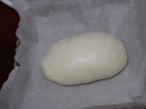 烤盘铺油纸，把揉好面团放进去，保鲜膜覆盖密封，放入冰箱冷藏发酵过夜。