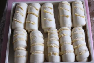 发酵面团两倍大，表面划口，冷藏的黄油切成小细条放入切口处，撒上粗砂糖。