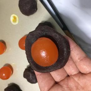 豆沙分成25克一个，包入蛋黄 ，用食指和拇指这间的虎口慢慢往上推，包好不要露出蛋黄
