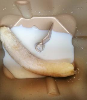 2.香蕉和牛奶放入面包机中，盐和糖分别放在面包桶的两个角上。