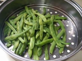 豆角入开水锅中煮熟，一定要充分煮熟噢，后面蒸的时候就省事了