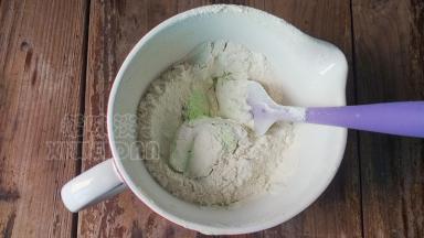 低筋面粉筛入黄油糊里用刮刀将面糊翻拌均匀至无颗粒