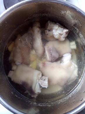 把猪脚洗干净后放生姜和老酒中火煮25-30分钟。