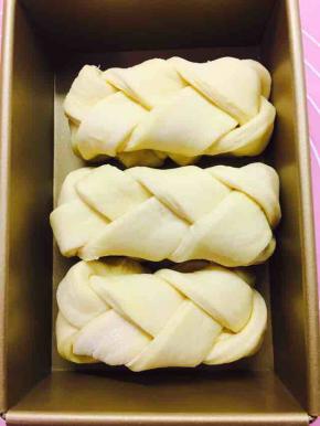 编好的辫子，向下折叠后，放入模具，发酵至模具8分满后盖上盖子，200度烤35至40分钟