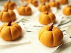 糯米圆子略微用手指按一下，蔓越莓干一切为二，插在凹痕处充当南瓜蒂，用牙签在糯米面团周围按出南瓜的痕迹。全部做好。