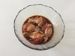 将姜片和所有调味料倒入鸡翅根中，用手抓匀腌制半小时；