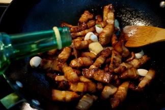 5.	将八角、大蒜、姜块入锅中，继续煸炒；倒入少许白酒，白酒比料酒去腥效果更好，而且还能添特别的香气；翻炒均匀，让酒挥发，带走肉腥气；