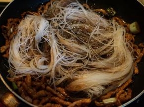 7.将泡软剪短的粉丝入锅中，迅速翻炒，使粉丝能吸入汤汁；
