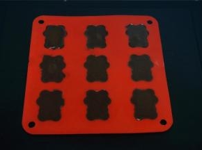 接着倒入液态巧克力至满，充分包裹大杏仁，震荡平整后放入冰箱冷冻至硬。