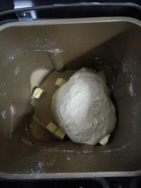 加入软化的黄油，继续揉面。