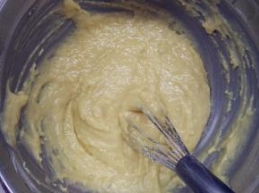 筛入低筋面粉、杏仁粉和泡打粉，用手动打蛋器将它们翻拌均匀。