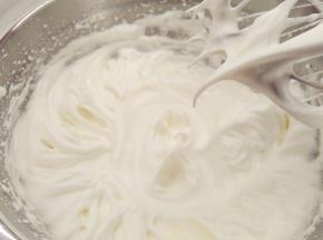 往蛋白中分3次加入糖粉，打至湿性发泡。（首先，用打蛋器低速将蛋白搅打至起鱼眼泡，加入1/3的糖粉。接着，继续用电动打蛋器高速搅打，至蛋白体积膨胀1倍，再加入1/3的糖粉。然后，继续用电动打蛋器中速搅打，稍微出现纹路，加入剩余的1/3的糖粉。最后低速搅打，直到提起打蛋器时出现鹰钩嘴即可。）