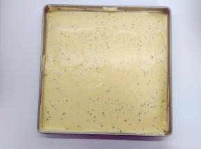 将面糊从15cm的高处倒入烤盘中，用刮刀稍微抹平，再震两下。