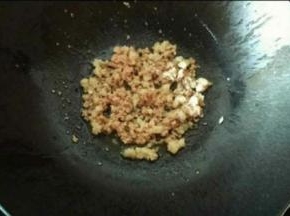 热锅下油，倒入肉末翻炒至变色，放入蒜末继续翻炒