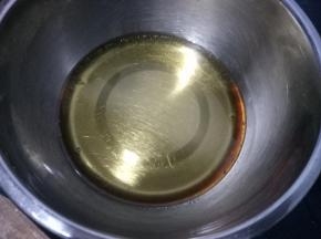 干净的盆中，放入 40克花生油，115克转化糖浆和2克枧水，搅匀，糖浆和油乳化好