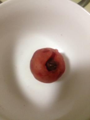 装巧克力酱裱花袋剪小口 把巧克力酱注入刚才做好的樱桃馅里 尽量注到洞里 轻轻磕一磕 让巧克力酱沉下去