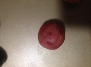 把口收紧 不要有裂缝 如果实在包不上 可以再取一点樱桃馅捏扁 扣在洞口抹平 千万不要有裂缝 要不然 下一步可能压模的时候 就露馅了 烘烤后会破