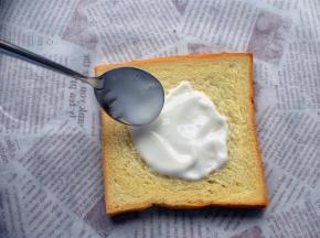 取一片方包片，抹上浓稠酸奶。