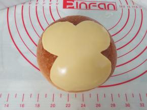 待面包冷却后，在面包上刷一层蜂蜜，然后将芝士片剪成猴脸形状，贴在面包上